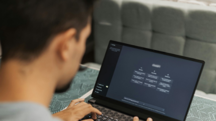 Man sitting at laptop asking an open AI for advice.